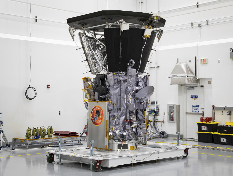 This July 6, 2018 photo made available by NASA shows the Parker Solar Probe in a clean room at Astrotech Space Operations in Titusville, Fla., after the installation of its heat shield. NASA's Parker Solar Probe will be the first spacecraft to "touch" the sun, hurtling through the sizzling solar atmosphere and coming within just 3.8 million miles (6 million kilometers) of the surface. (Ed Whitman/Johns Hopkins APL/NASA via AP)