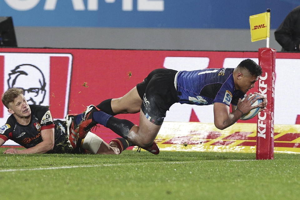 Blues winger Caleb Clarke scores a try during the Super Rugby final between the Chiefs and the Blues in Auckland, New Zealand, Saturday, June 22, 2024. (David Rowland/Photosport via AP)