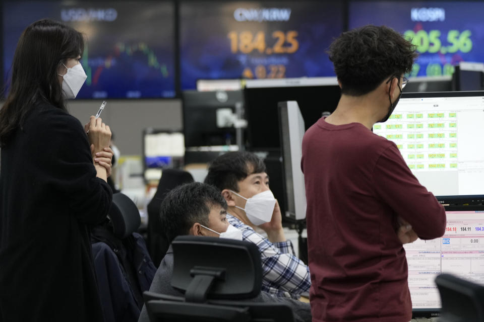 Currency traders watch monitors at the foreign exchange dealing room of the KEB Hana Bank headquarters in Seoul, South Korea, Friday, Oct. 22, 2021. Asian shares were mixed Friday after a late-in-the-day wave of buying pushed the S&P 500 to a fresh record high. (AP Photo/Ahn Young-joon)