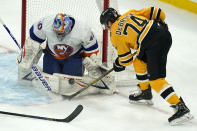 New York Islanders goaltender Semyon Varlamov (40) makes a pad-save on a shot by Boston Bruins left wing Jake DeBrusk (74) in the first period of an NHL hockey game, Thursday, April 15, 2021, in Boston. (AP Photo/Elise Amendola)