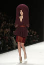 <b>Berlin Fashion Week</b>: A model dons a crocheted burgundy headpiece that doubles up as a pair of gloves on the Leandro Cano catwalk.<br><br>Image © Rex