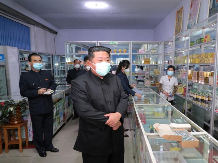 North Korean leader Kim Jong Un wears a face mask amid the coronavirus disease (COVID-19) outbreak, while inspecting a pharmacy in Pyongyang