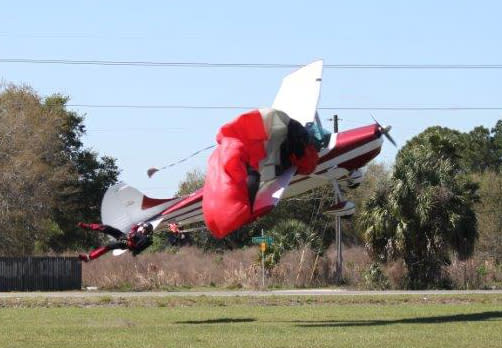 This photo released by the Polk County Sheriff's Office shows a plane getting tangled with a parachutist, Saturday March 8, 2014, at the South Lakeland Airport in Mulberry, Fla. Both the pilot and jumper hospitalized with minor injuries. (AP Photo/Polk County Sheriff's Office, Tim Telford) MANDATORY CREDIT