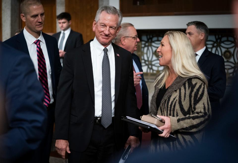 Sen. Tommy Tuberville, R-Ala., speaking with Rep. Marjorie Taylor Greene, R-Ga., right, during a Joint Conference Committee meeting of conferees on H.R.2670, to authorize appropriations for fiscal year 2024 for military activities of the Department of Defense.