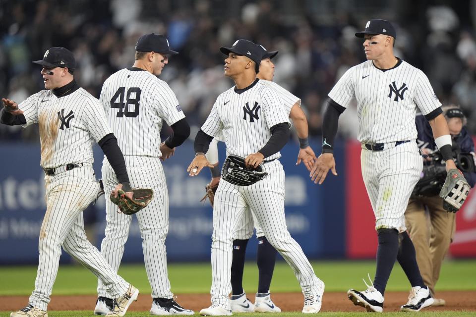 New York Yankees' Aaron Judge, front right, Juan Soto, second from front right, Anthony Rizzo, second from left, and Alex Verdugo, left, celebrate after a baseball game against the Tampa Bay Rays, Friday, April 19, 2024, in New York. (AP Photo/Frank Franklin II)