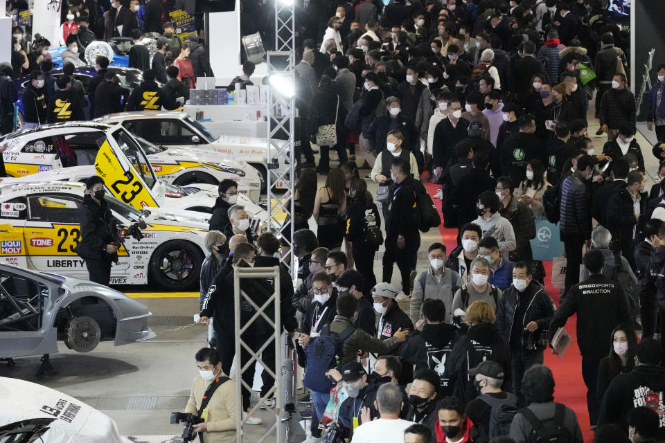 Guests visit booths at the Tokyo Auto Salon, an industry event similar to the world's auto shows Friday, Jan. 13, 2023, in Chiba near Tokyo. (AP Photo/Eugene Hoshiko)