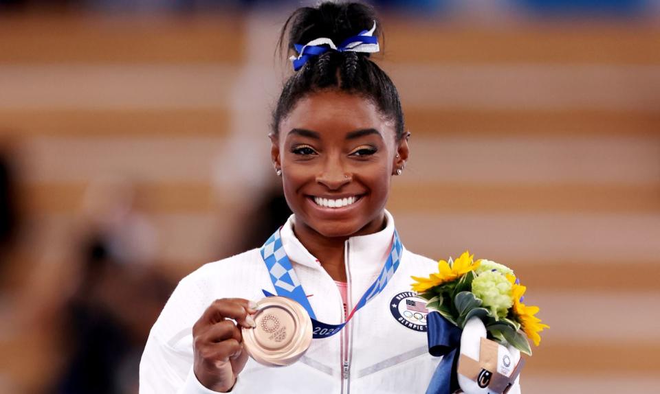 Simone Biles poses with the bronze medal during the Women's Balance Beam Final medal ceremony at the Tokyo 2020 Olympic Games on August 3, 2021 in Tokyo. / Credit: Jamie Squire/Getty Images  