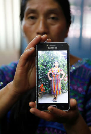 Dominga Vicente shows a picture of her relative Claudia Gomez, a Guatemalan immigrant killed by an US Border Patrol officer on Wednesday while entering illegally to Texas, during a news conference in Guatemala City, Guatemala May 25, 2018. REUTERS/Luis Echeverria