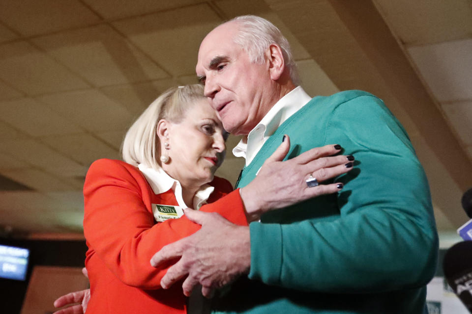 FILE - In this Nov. 6, 2018, file photo, Rep. Mike Kelly, right, embraces his wife, Victoria Kelly after giving his victory speech to supporters in Butler, Pa. A congressional ethics watchdog has concluded there is “substantial reason to believe” that Victoria Kelly used nonpublic information gained through her husband's position in Congress to purchase stock last year, a likely violation of federal law and House rules. (AP Photo/Keith Srakocic, File)