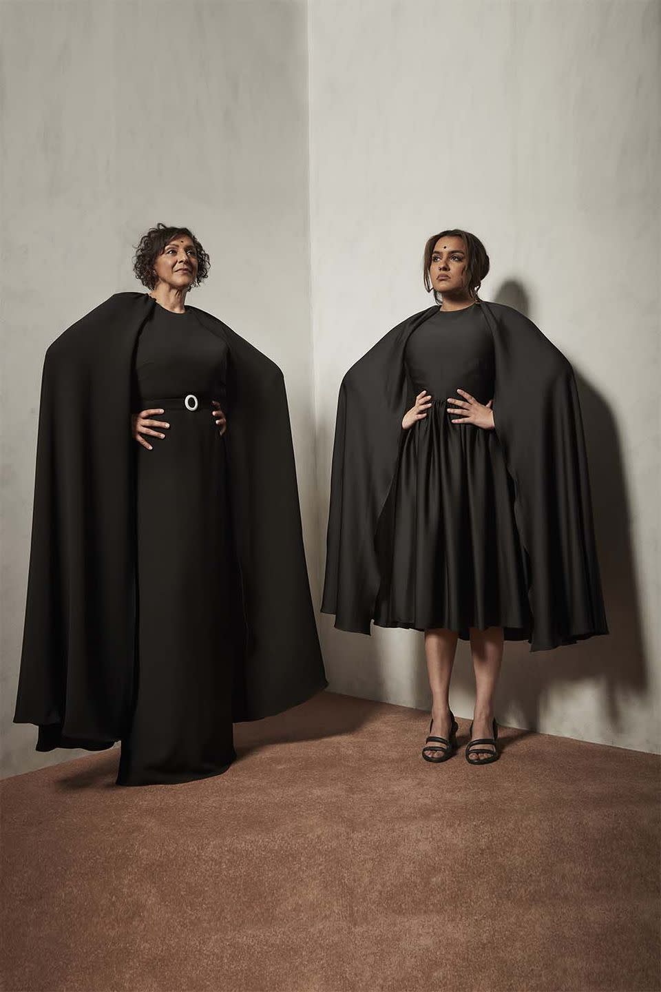 a couple of women in black dresses