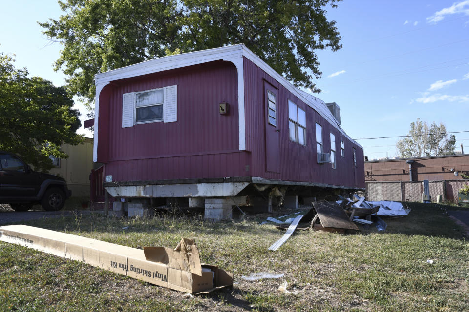 ADVANCE ON THURSDAY, SEPT. 12 FOR USE ANY TIME AFTER 3:01 A.M. SUNDAY SEPT 15 - In this Aug. 30th 2019 photo shows a home sitting with a vinyl skirting kit in boxes on the ground, seemingly ready for replacement at Lamplighter Village, a manufactured and mobile home park in Federal Heights, Colo. Across Colorado, where the housing crisis impacts both rural and urban towns, the strife between mobile home park residents and park owners approaches a boiling point. The business model -- in which homeowners pay lot rent to park their houses on someone else's land -- capitalizes on the immobility and economic fragility of tenants who often can't afford to move or live anywhere else. (Kathryn Scott/The Colorado Sun)