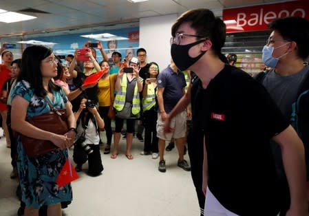 Pro-China demonstrators and anti-government protesters argue at Amoy Plaza shopping mall in Kowloon Bay, Hong Kong