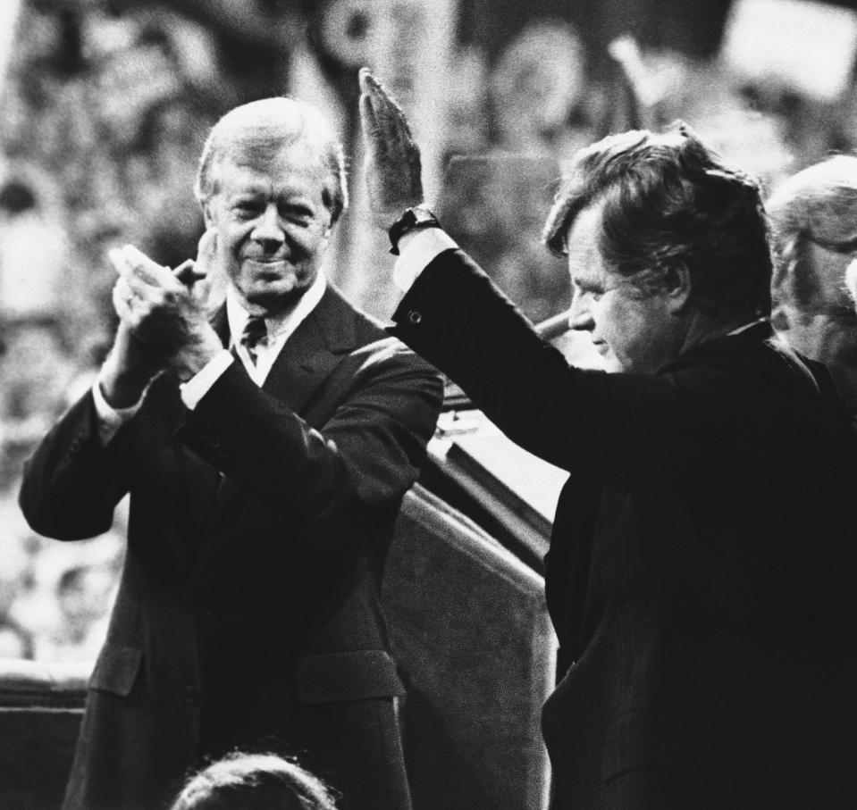 FILE - U.S. President Jimmy Carter, left, applauds as Sen. Edward Kennedy waves to cheering delegates at the Democratic National Convention in New York's Madison Square Garden, Aug. 14, 1980. As Carter receives home hospice care at the age of 98, misconceptions about his life are coming into focus. Most are rooted in some truth but need more context. (AP Photo, File)