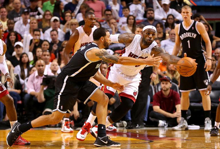 LeBron James of the Miami Heat steals a pass from Deron Williams of the Brooklyn Nets during a game at AmericanAirlines Arena on April 8, 2014 in Miami, Florida