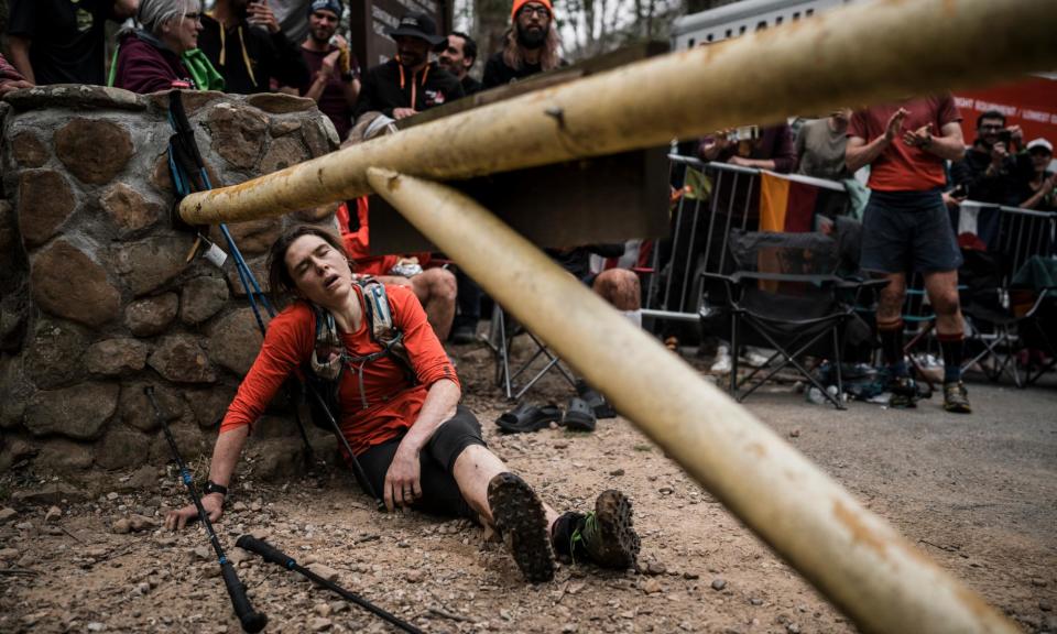 <span>An exhausted Jasmin Paris slumps to the ground after finishing the Barkley Marathons.</span><span>Photograph: Jacob Zocherman</span>