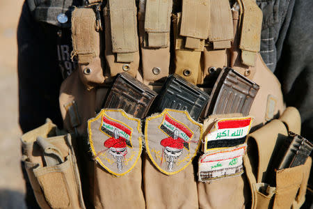 A member of the Iraqi Army carries a pouch with magazines during clashes with Islamic State militants at the south of Mosul, Iraq December 12, 2016. REUTERS/Ammar Awad