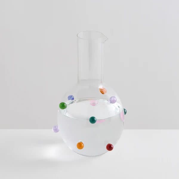 a glass vase with coloured dots