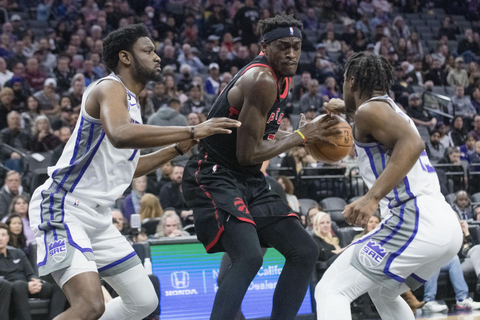 Sacramento Kings forward Chimezie Metu, left, and Sacramento Kings guard Davion Mitchell guard Toronto Raptors forward Pascal Siakam during the first quarter of an NBA basketball game in Sacramento, Calif., Wednesday, Jan. 25, 2023. (AP Photo/Randall Benton)