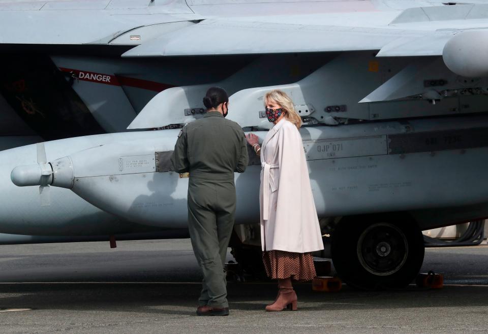 First lady Jill Biden gets a tour of a Growler aircraft by Naval Aviator Lt. Cate Oakley, March 9, 2021, at Naval Air Station Whidbey Island in Oak Harbor, Wash.