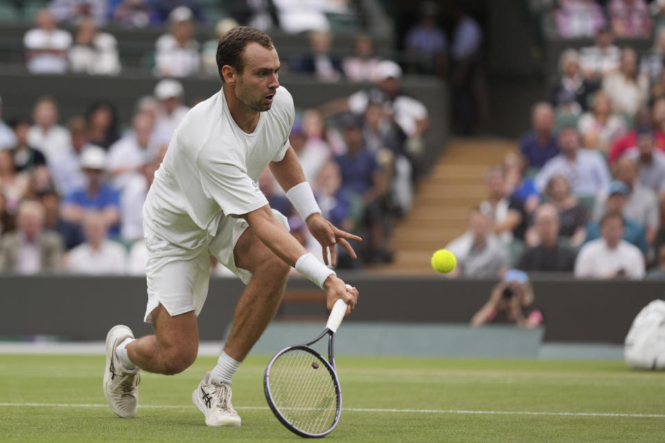 Russia's Roman Safiullin in action against Italy's Jannik Sinner during their men's singles match on day nine of the Wimbledon tennis championships in London, Tuesday, July 11, 2023. (AP Photo/Alberto Pezzali)