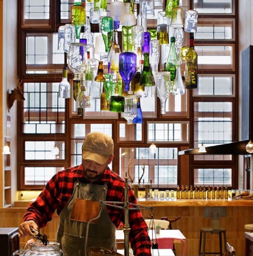 Detalles que hacen la diferencia. En el interior se destaca una imponente lámpara construida con botellas de cristal de todos colores. Además, cada una de las ventanas que vemos aquí han sido encontradas en casas abandonadas de la zona y reutilizadas de una manera muy original. 