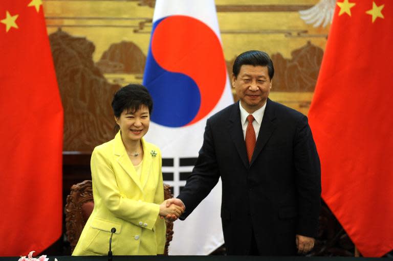 South Korean President Park Geun-Hye shakes hands with her Chinese counterpart Xi Jinping after a ceremony at the Great Hall of the People in Beijing, on June 27, 2013