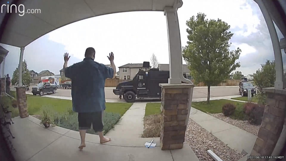 FILE - In this image from video provided by Leslie Bowman, Anderson Lee Aldrich surrenders to police at a home where his mother, Laura Voepel, was renting a room in Colorado Springs, Colo., on June 18, 2021. According to sealed law enforcement documents verified by The Associated Press, Aldrich's actions brought SWAT teams and the bomb squad to the normally quiet neighborhood, forced the grandparents to flee for their lives and prompted the evacuation of 10 nearby homes to escape a possible bomb blast. (Leslie Bowman via AP)