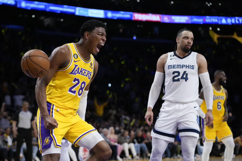 Los Angeles Lakers' Rui Hachimura (28) celebrates his dunk next to Memphis Grizzlies' Dillon Brooks (24) during the first half in Game 6 of a first-round NBA basketball playoff series Friday, April 28, 2023, in Los Angeles. (AP Photo/Jae C. Hong)