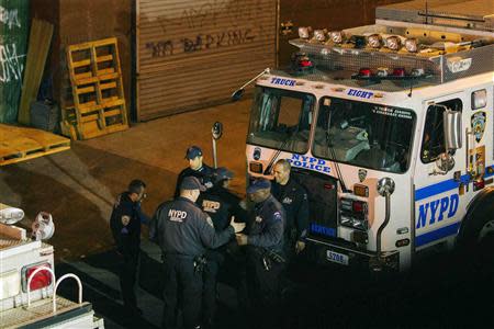 New York Police Department Officers depart a multiple shooting crime scene on Maujer Street in the Brooklyn borough of New York, November 11, 2013. REUTERS/Lucas Jackson