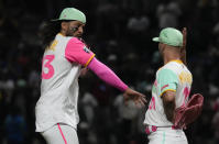 San Diego Padres Fernando Tatis Jr., left, celebrates with his teammate Nick Martinez after their team's victory 1over San Francisco Giants during a baseball game in Mexico City, Saturday, April 29, 2023. (AP Photo/Fernando Llano)