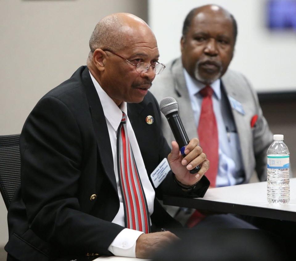 Charles Goston, left, then a candidate for the Gainesville City Commission, speaks during a African American Accountability Alliance candidate forum on Feb. 16, 2015. [Brad McClenny/Staff Photographer]