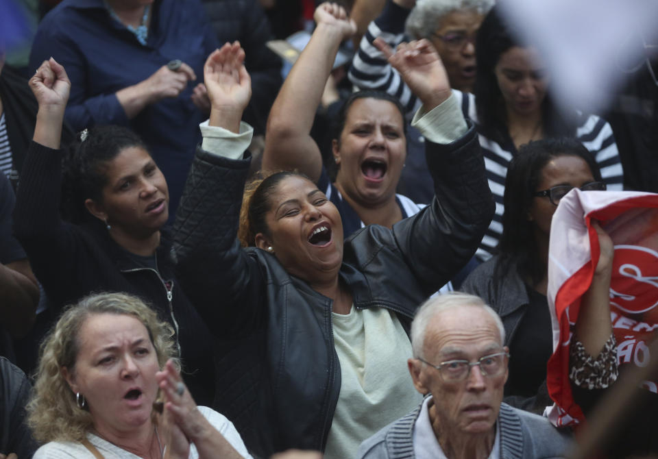 People shout slogans against Brazil's president Jair Bolsonaro during a protest against the pension reforms proposed by Bolsonaro's government, in Sao Paulo, Brazil, Friday, March 22, 2019. (AP Photo/Andre Penner)