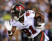 FILE - Tampa Bay Buccaneers wide receiver Antonio Brown runs with the ball during an NFL football game against the Philadelphia Eagles, Oct. 14, 2021, in Philadelphia. Brown and two other NFL players have been suspended immediately for three games by the league for violating COVID-19 protocols. Brown and teammate Mike Edwards were suspended Thursday, Dec. 2, 2021. Free agent John Franklin III, if signed by a team, is also ineligible to play in the next three games. (AP Photo/Matt Rourke, File)