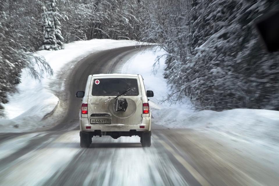 A medical car moves along a snowy road carrying COVID-19 vaccines heading to the village of Ikhala in Russia’s Karelia region, Tuesday, Feb. 16, 2021. Russia’s rollout of its coronavirus vaccine is only now picking up speed in some of its more remote regions, although experts say the campaign is still moving slowly. (AP Photo/Dmitri Lovetsky)