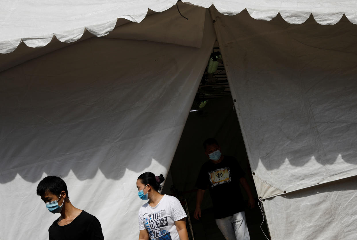 People leave a tent used as a thermal scanning station, while buying groceries, amid the outbreak here on 23 April. 2020. (PHOTO: Reuters)