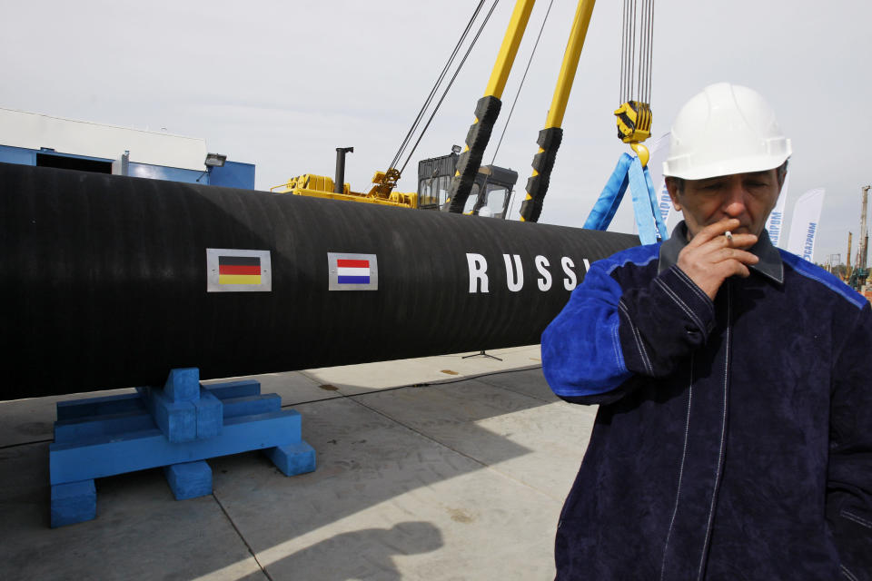 FILE - A Russian construction worker smokes in Portovaya Bay some 170 kms (106 miles) north-west from St. Petersburg, Russia, on April 9, 2010, during a ceremony marking the start of Nord Stream pipeline construction. Russia's Gazprom state-controlled energy giant said it will shut down the Nord Stream 1 natural gas pipeline to Germany for three days of maintenance starting Wednesday, raising economic pressure on Germany and other European countries that depend on the fuel to power industry, generate electricity and heat homes. (AP Photo/Dmitri Lovetsky, File)