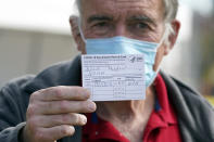 Dr. Michael Roach, a specialist in internal medicine and geriatrics, shows his vaccination card after receiving the Moderna COVID-19 vaccine at a site for health care workers at Ritchie Valens Recreation Center Wednesday, Jan. 13, 2021, in Pacoima, Calif. (AP Photo/Marcio Jose Sanchez)