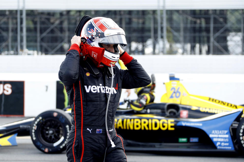 Will Power walks down pit road as inclement weather delays an IndyCar Series auto race at Pocono Raceway, Sunday, Aug. 18, 2019, in Long Pond, Pa. (AP Photo/Matt Slocum)