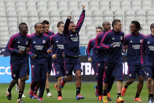 Lyon's team players warm up during a training session on April 27, at the Stade de France in Saint-Denis, outside Paris, on the eve of their French Cup final match against Quevilly