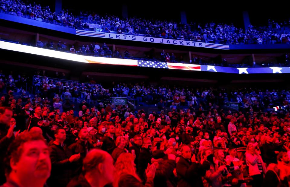 Fans stand for the National Anthem prior to the NHL hockey game between the Columbus Blue Jackets and the Detroit Red Wings at Nationwide Arena in Columbus on Monday, Nov. 15, 2021. 