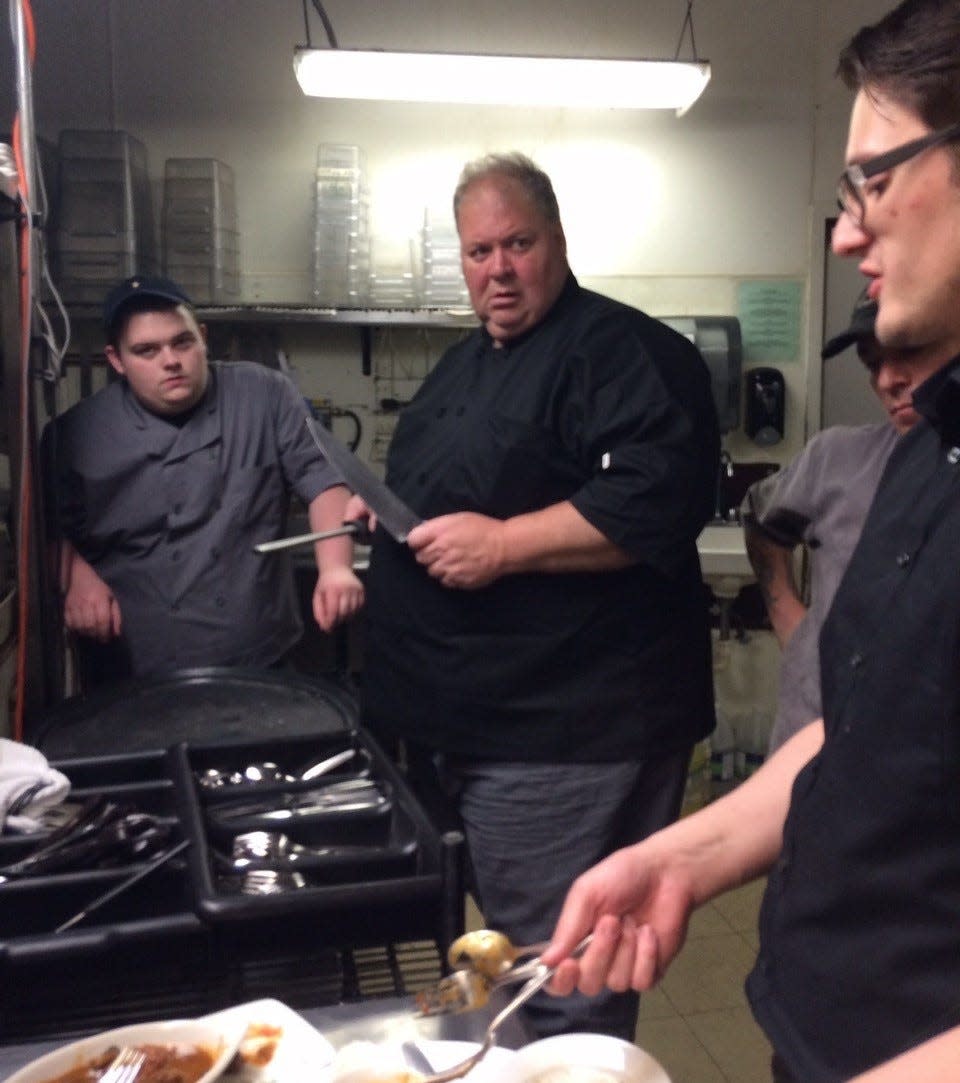 Chef Kevin Cronin (center) with fellow staff at Dusty’s Cellar and Wine Bar, where he worked as the executive chef for 20 years.