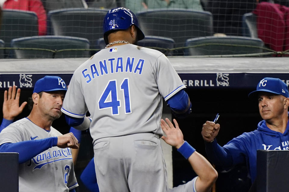 Kansas City Royals manager Mike Matheny, left, greets Carlos Santana (41) at the dugout steps after Santana hit a solo home run off reliever Zach Britton during the eighth inning of a baseball game against the New York Yankees, Wednesday, June 23, 2021, at Yankee Stadium in New York. (AP Photo/Kathy Willens)