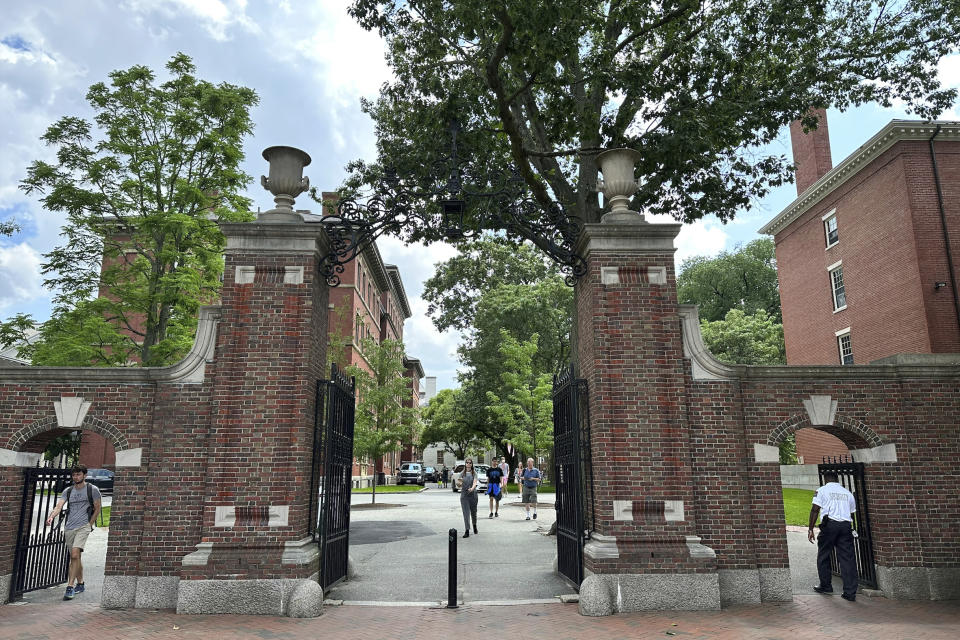 FILE - Students walk through a gate at Harvard University, Thursday, June 29, 2023, in Cambridge, Mass. In the wake of a Supreme Court decision that removes race from the admissions process, colleges are coming under renewed pressure to put an end to legacy preferences, the practice of favoring applicants with family ties to alumni. At Harvard, which released years of records as part of the lawsuit that ended up before the Supreme Court, legacy students were eight times more likely to be admitted, and nearly 70% were white, researchers found. (AP Photo/Michael Casey)