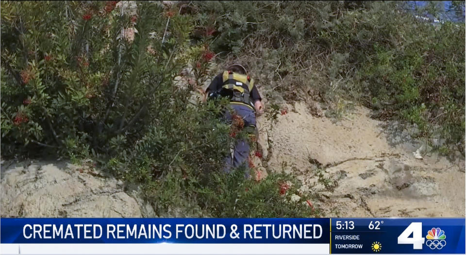 This Wednesday, Jan. 22, 2020 video image courtesy of NBC4 shows a coastal clean-up crew retrieving a box with cremated human remains found in a cliff in Long Beach, Calif. The California coastal cleanup crew ended months of anguish for a grieving family with the discovery of cremated remains of loved ones that had been in a van that was stolen before a funeral service. Damadis Sanchez was 34 when she was killed along with her 8-year-old son, Anthony, in a traffic accident in Texas. Her brother, Gerson Lopes, had their remains returned to the family near LA. Last April, the family was preparing for a memorial service when a van with the ashes inside was stolen. Lopes says it was like a weight off his shoulders to finally get the remains. (NBC4-TV via AP)