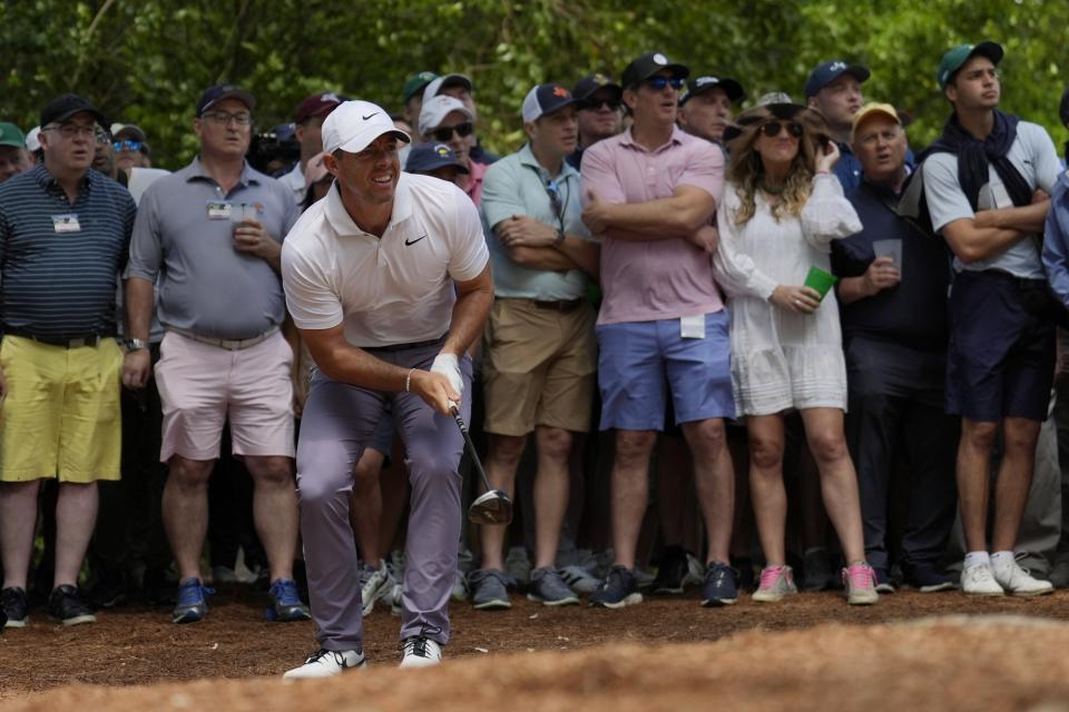 Rory McIlroy, of Northern Ireland, watches his shot from the pine straw on the second hole during the first round at the Masters golf tournament at Augusta National Golf Club Thursday, April 11, 2024, in Augusta, Ga. (AP Photo/Ashley Landis)