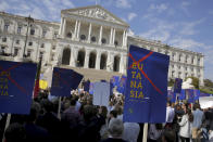 Demonstrators protest outside the Portuguese parliament in Lisbon, Thursday, Feb. 20, 2020. Protesters gathered Thursday outside Portugal's where lawmakers were due to debate proposals that would allow euthanasia and doctor-assisted suicide. Groups which oppose the procedures waved banners and chanted "Sim a vida!" ("Yes to life!") in bright sunshine outside the parliament building in Lisbon. One banner said, "Euthanasia doesn't end suffering, it ends life." (AP Photo/Armando Franca)