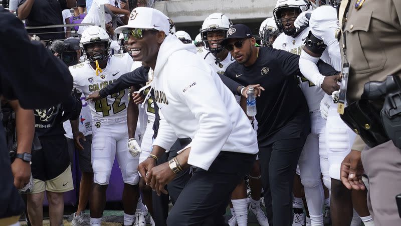 Colorado head coach Deion Sanders runs onto the field with his team for an NCAA college football game against TCU Saturday, Sept. 2, 2023, in Fort Worth, Texas.