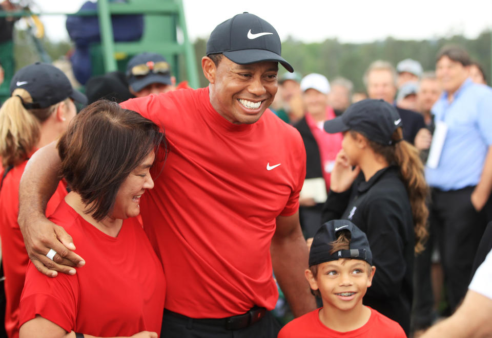 Tiger Woods of the United States celebrates with his son Charlie Axel as he comes off the 18th hole in honor of his win during the final round of the Masters at Augusta National Golf Club on April 14, 2019 in Augusta, Georgia. (Photo by Andrew Redington/Getty Images)
