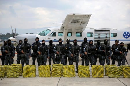 FILE PHOTO: Police officers are seen in front of packages containing cocaine seized during operations in Retalhuleu and San Marcos southwest of Guatemala City