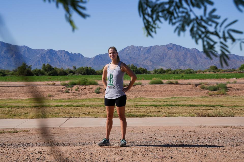 Rebecca Perrera poses for a portrait on the Laveen Area Conveyance Channel on Oct. 1, 2022, in Laveen Village. Perrera serves on the HOA board and often uses the canal, which has been damaged by erosion due to neglect, to commute to Starbucks and spend time with her family. She, along with residents, local schools and town committees, are pushing for city funding from the 2023 GO Bond to implement safe pedestrian crossings and fix irrigation issues and erosion on the path.